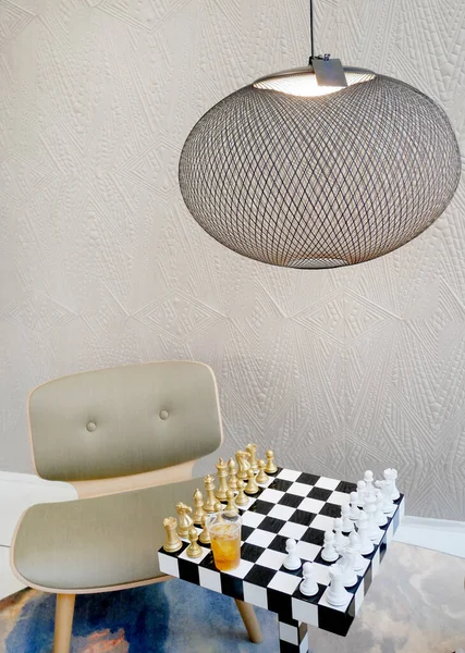 chess game table, chair, chessboard and modern lamp