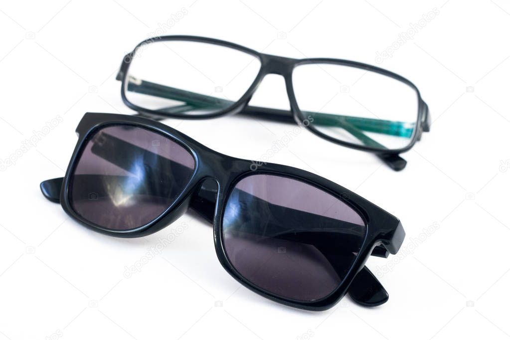 Two pairs of glasses: sunglasses and corrective eye glasses