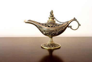 Alladin's Oriental eastern candle lamp with a djinn inside clipart
