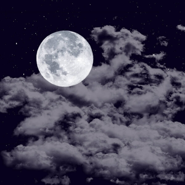 Full moon on the cloudy sky in the dark night