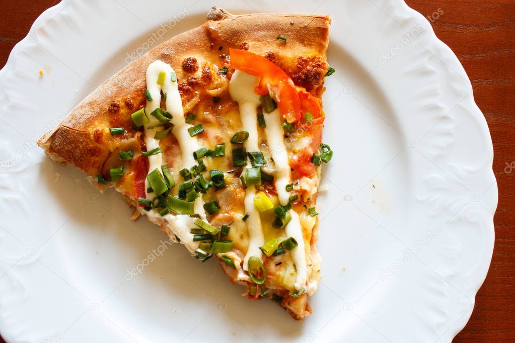 Slice of pizza with mayonnaise on plate detail. Wooden table — Stock