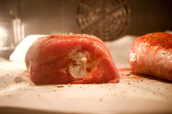 Cut Raw turkey meat slices inside the oven