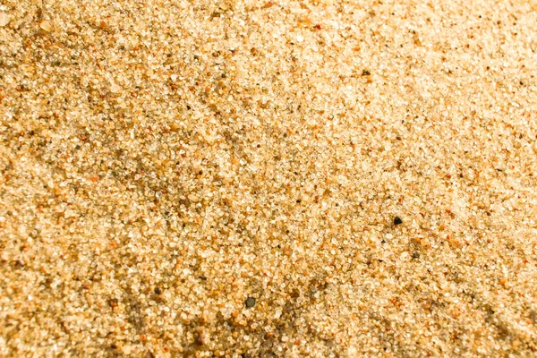 Arena macro textura de fondo. Arena dorada en una playa —  Fotos de Stock