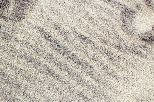 Dirty sand with black stripes pattern on beach background — Stock Photo, Image