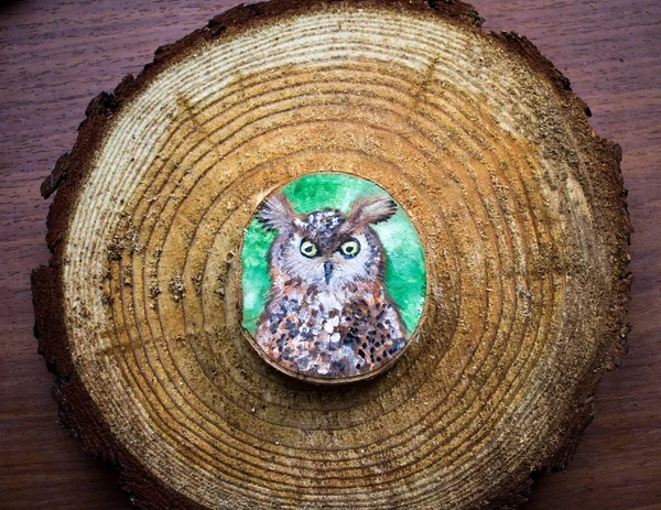 Painted forest animal on a cut piece of wood. Beautiful natural