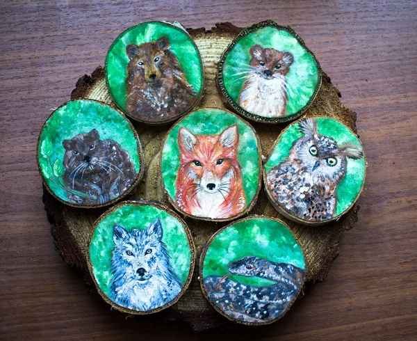 Collection of painted forest animals on a cut pieces of wood. Be