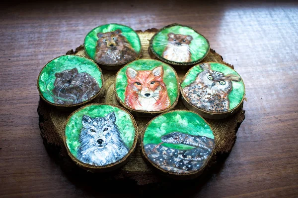 Collection of painted forest animals on a cut pieces of wood. Be