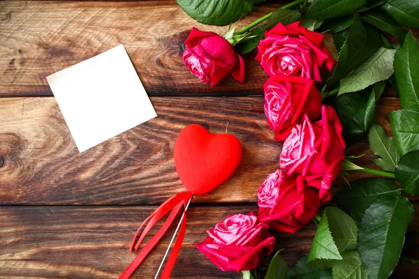 Bouquet of red roses on wooden background. Valentine's Day backg Stock Image