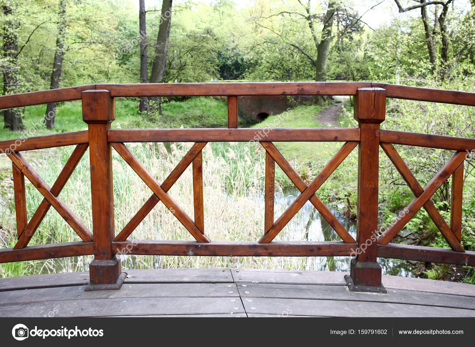 Simple Wooden Bridge Over A Small River In Green Park Polan Simple Wooden Bridge Over A Small River In Green Park Polan Stock Photo