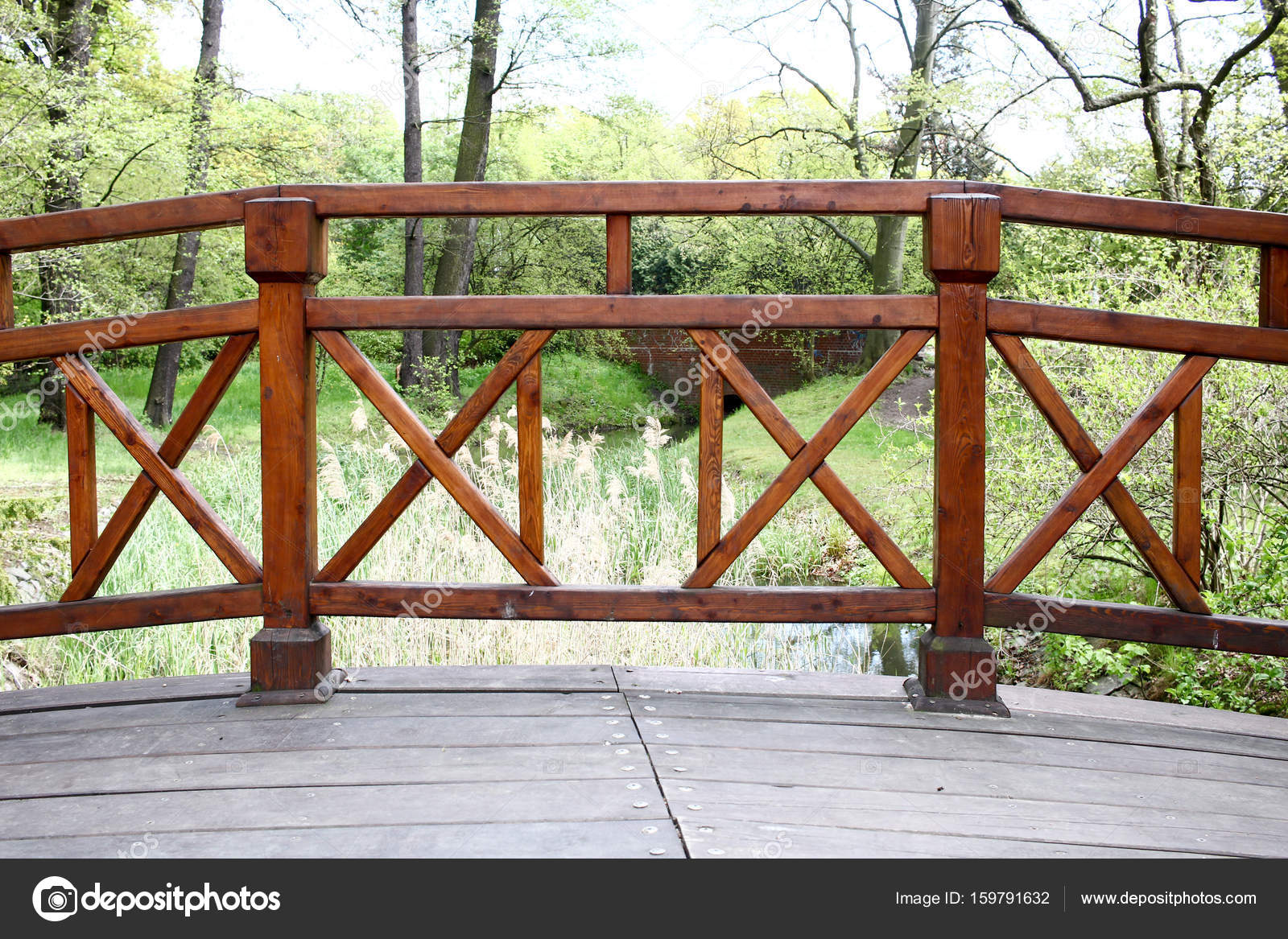 Simple Wooden Bridge Over A Small River In Green Park Polan Simple Wooden Bridge Over A Small River In Green Park Polan Stock Photo