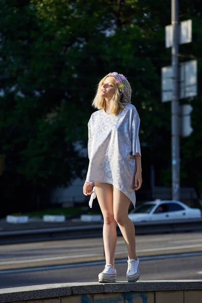 Junges blondes Mädchen mit funkelndem Hut läuft auf der Straße — Stockfoto