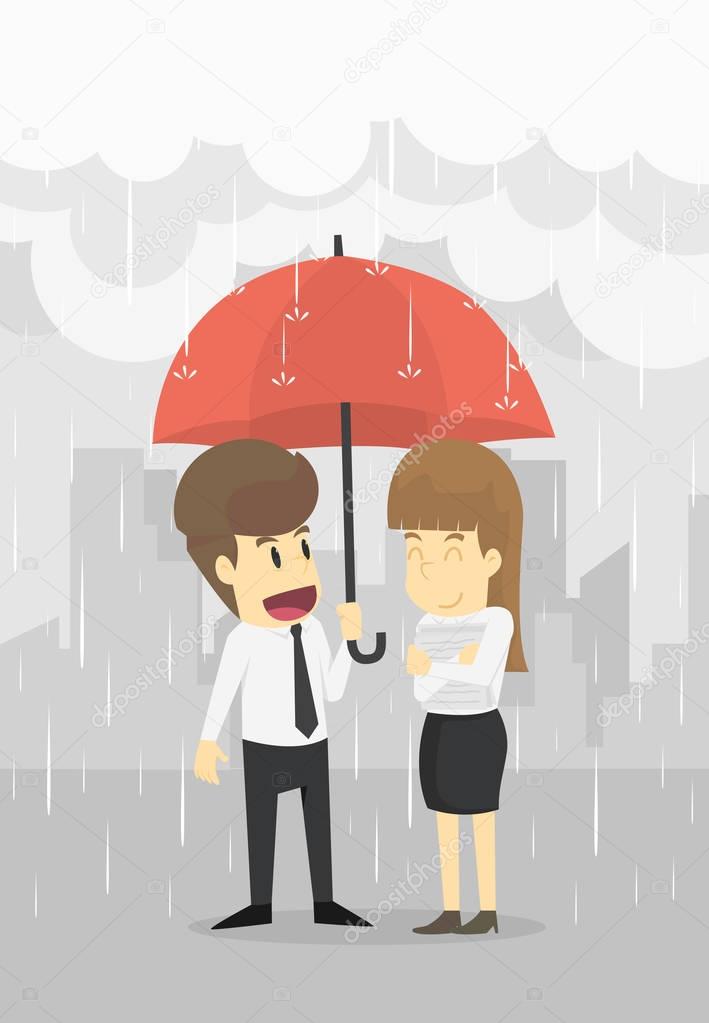 Businessman and Businesswoman stand together in rain with an umb