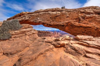 Sandstone arch over the canyon.  clipart