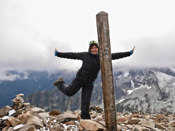 stock image Smiling adult woman on mountain top, feeling happy and successful. 