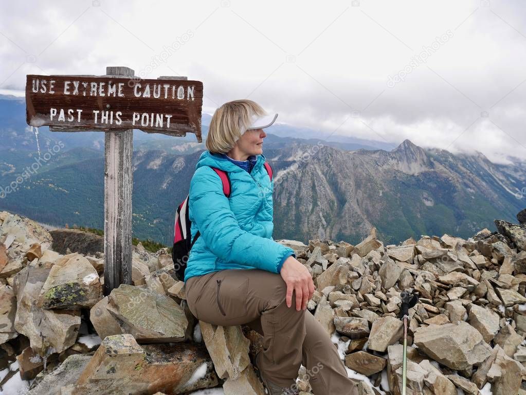 Adult woman on mountain top. 
