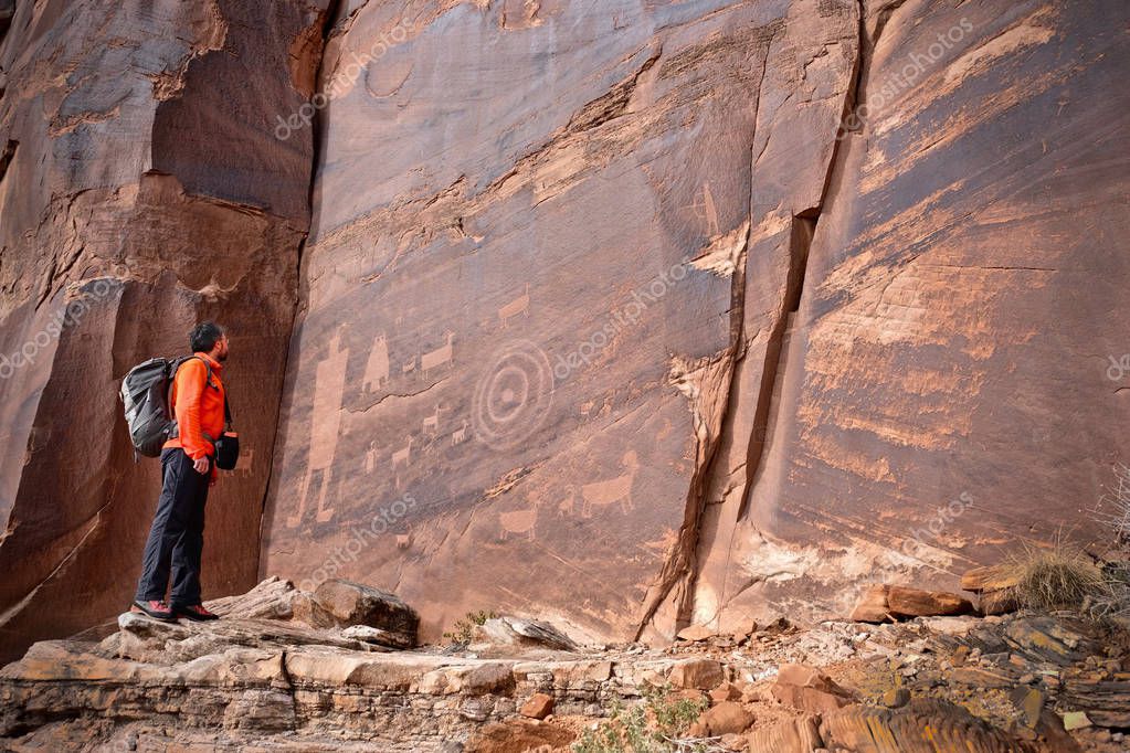 Owl, thunderbird, goat and a man figure petroglyphs on sandstone wall near Moab in Utah. Moab. Utah. United States.