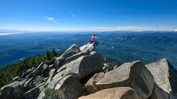 Vrouw op de berg top mediteren boven prachtig uitzicht. — Stockfoto