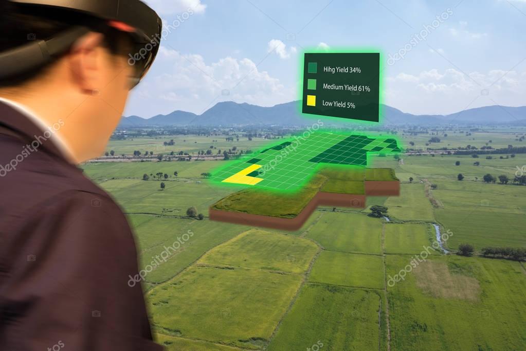 Iot smart industry 4.0 agriculture concept,agronomist,farmer(blurred) using smart glasses (augmented mixed virtual reality,artificial intelligence technology) to track, keep, collect about farm in 3d