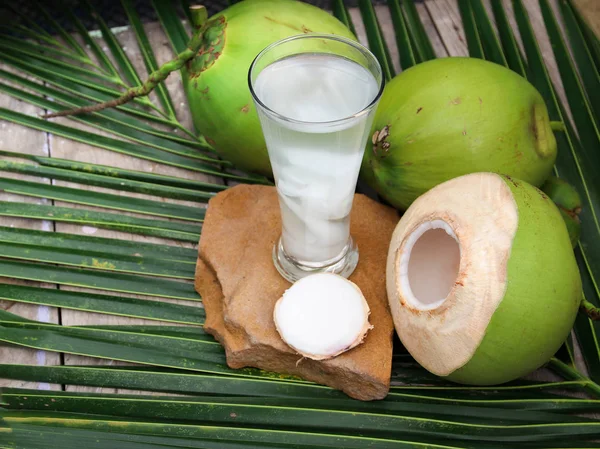 Gros plan sur la boisson fraîche à l'eau de coco en verre pour une bonne santé sur fond de bois . — Photo