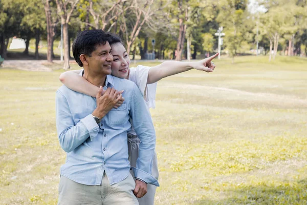 Adult male and female couples in the park.