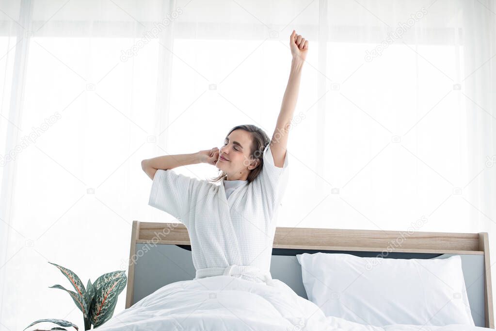 Woman stretching after waking up in the morning.