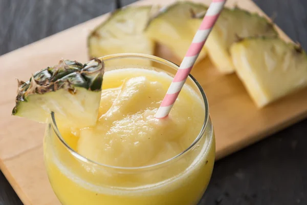 Pineapple smoothie on wood background — Stock Photo, Image