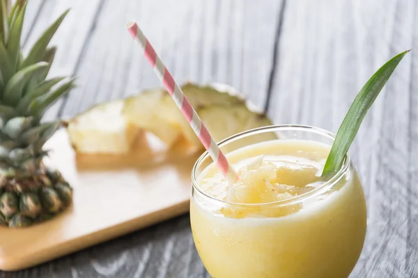 pineapple smoothie on wood background