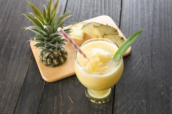 pineapple smoothie on wood background