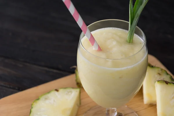 Pineapple smoothie on wood background — Stock Photo, Image