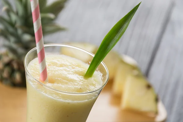 Pineapple smoothie on wood background — Stock Photo, Image