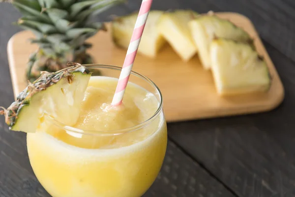 pineapple smoothie on wood background