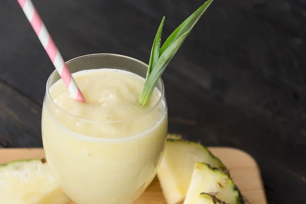 Pineapple smoothie on wood background — Stock Photo, Image