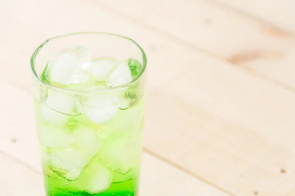 Green soda on wood background — Stock Photo, Image