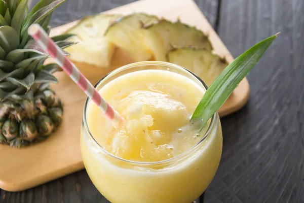 Pineapple smoothie on wood background — Stock Photo, Image