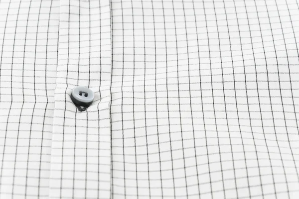 Nära håll knapp på skjorta — Stockfoto