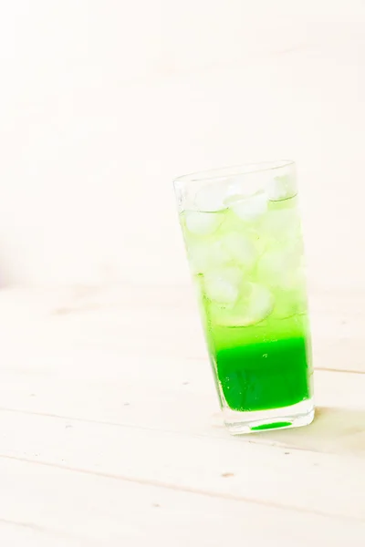 Green soda on wood background — Stock Photo, Image