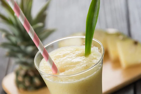 Pineapple smoothie on wood background — Stock Photo, Image