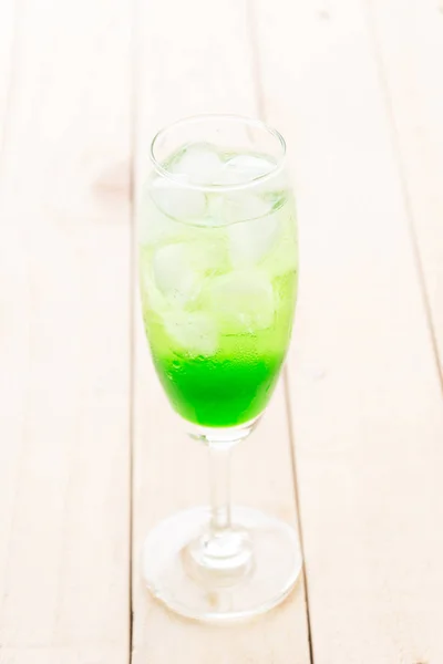 Green soda on wood background — Stock Photo, Image