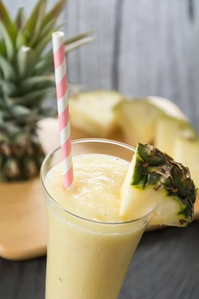 Pineapple smoothie on wood background — Stock Photo, Image