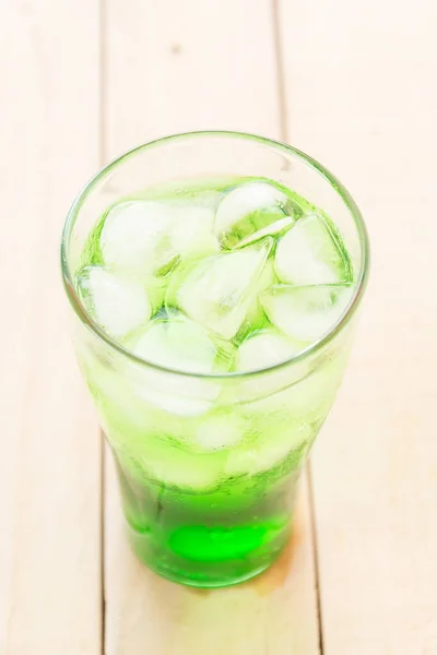 Green soda on wood background — Stock Photo, Image