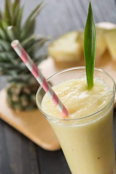 Pineapple smoothie on wood background — Stock Photo, Image