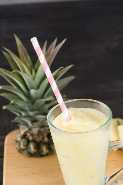 pineapple smoothie on wood background