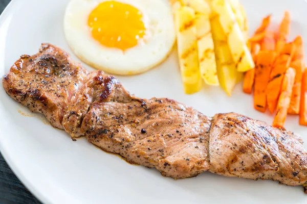 Bife de porco no fundo de madeira — Fotografia de Stock