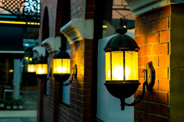 Lamp against a red brick wall at night. — Stock Photo, Image