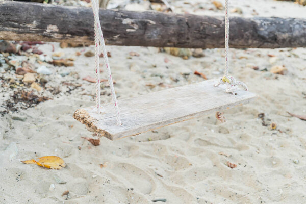 white swing on beach