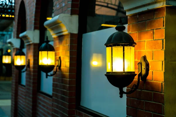 Lamp against a red brick wall at night. — Stock Photo, Image