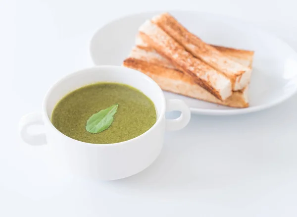 Spinach soup with spinach leaves and bread