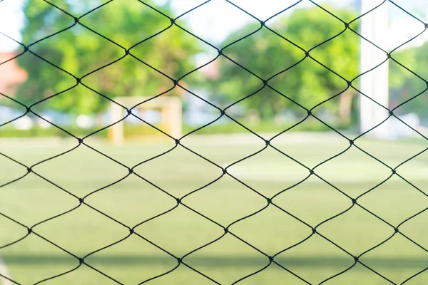 close-up net with soccer field background