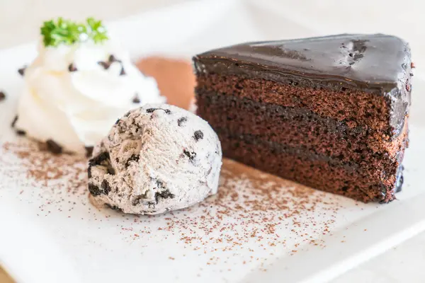 Chocolate cake with ice-cream and whipped cream — Stock Photo, Image