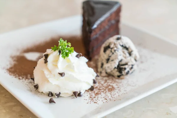 Chocolate cake with ice-cream and whipped cream — Stock Photo, Image